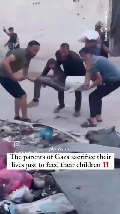 People trying to get food bags from a moving supply truck 