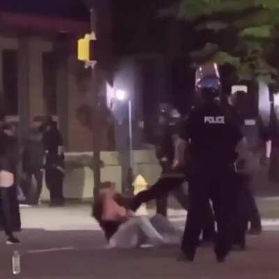 Police in Erie PA kicking down a peaceful protestor