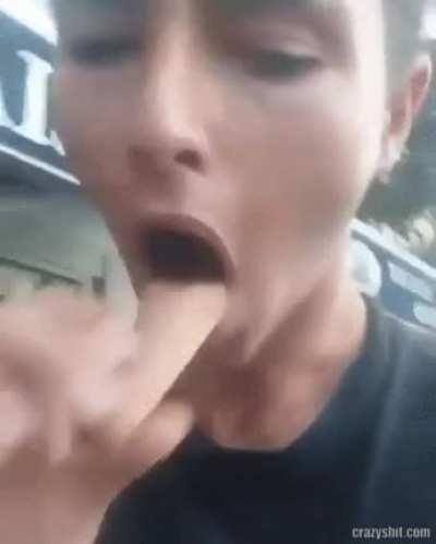 Guy smoking cigarette through an ice cream cone