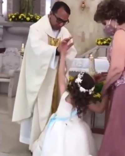 Priest was giving a blessing to a girl and she thought it was a high five