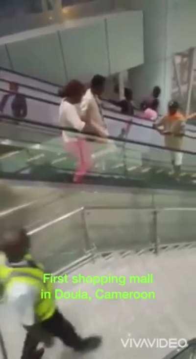 People using an escalator for the first time.