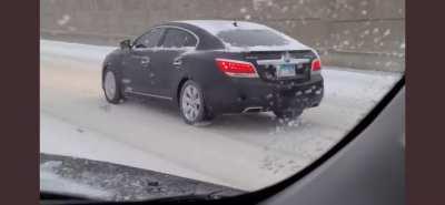 Driver in highway has no idea his rear tire is stuck in ice