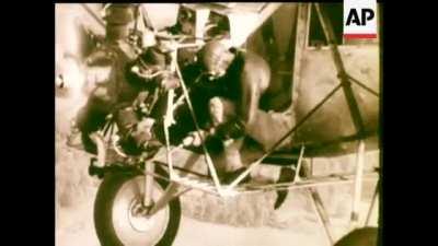 Fred Keys performs in-flight engine maintenance on Curtiss Robin 