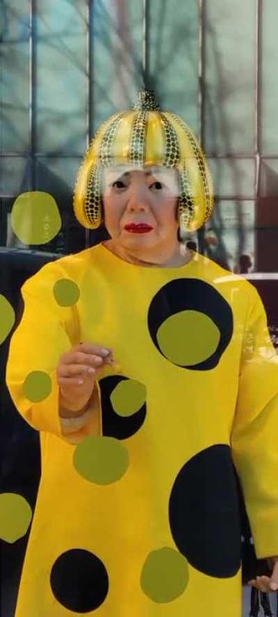 this yayoi kusama robot painting a window in tokyo