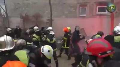 French police charging firefighters, firefighters not having any of it