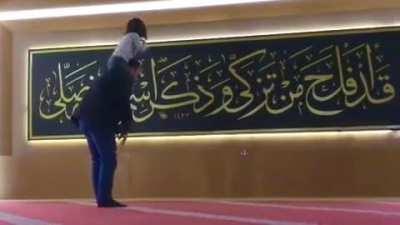 daughter plays with her father while he prays