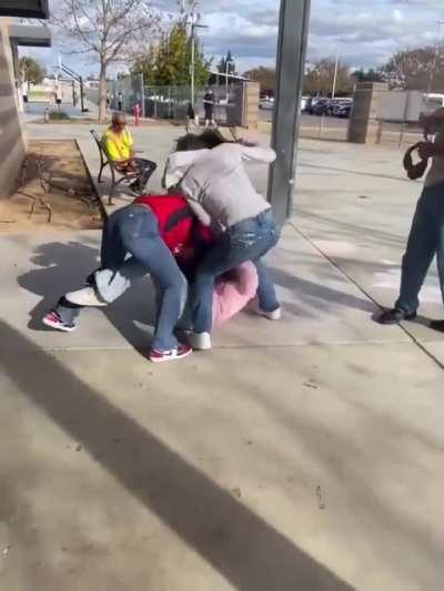 Boy tries to break up fight between three girls using what looks to be a sock full of rocks