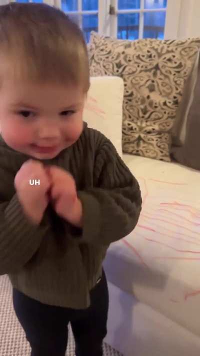 Proudly showing off his artwork.