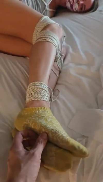 Cute girl tied up on the bed