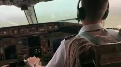 Landing plane in turbulent weather with low visibility and rain