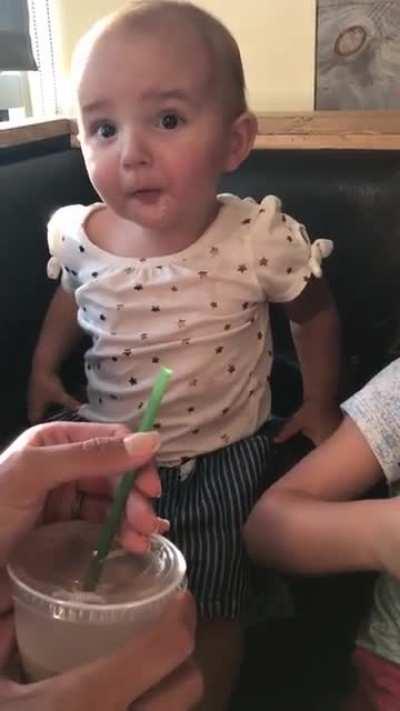 Baby tasting chocolate milk for the first time