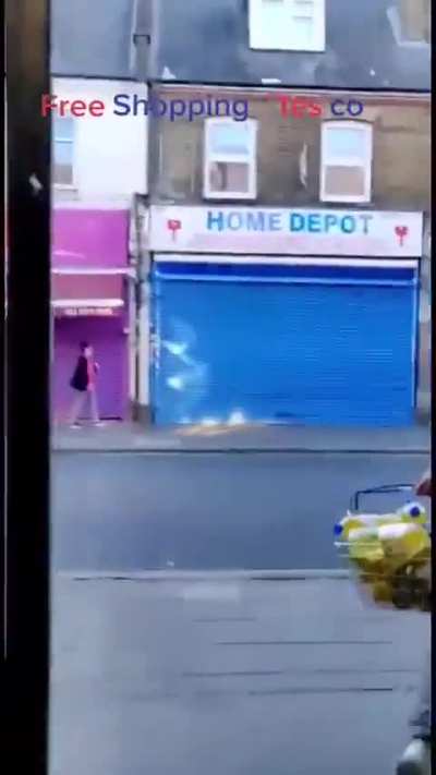 A shopper casually exits a Tesco in Southall without paying, while the staff looks on.