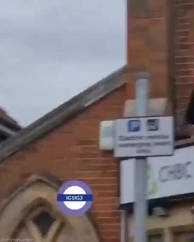 Muslim immigrant tearing down Christian cross from a church in England