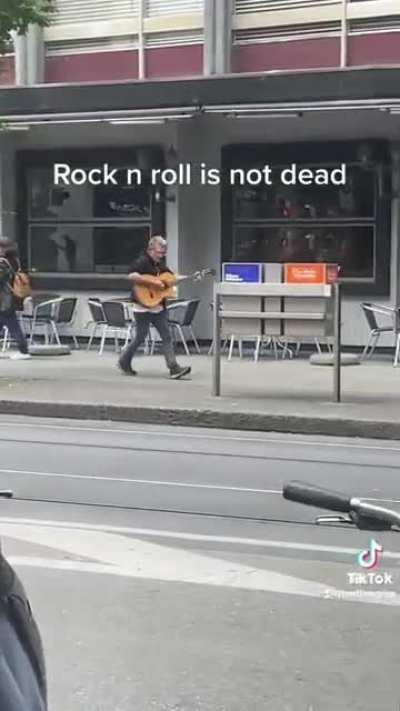 Guy plays guitar and kicks mailbox