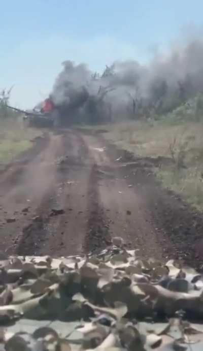 Russian soldiers record a Russian T-80 burning.