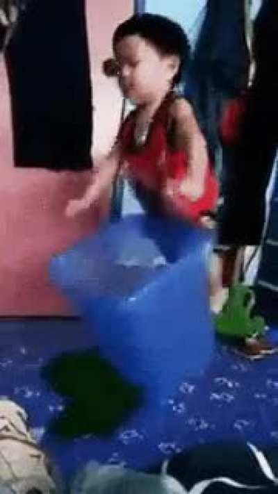 Kid tries to pin the hamper