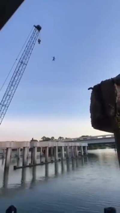 Man jumps off a crane