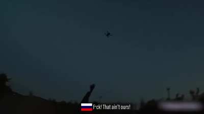 RU solider shoots down UA drone while travelling on a moving vehicle, location and date unknown. Music from source.