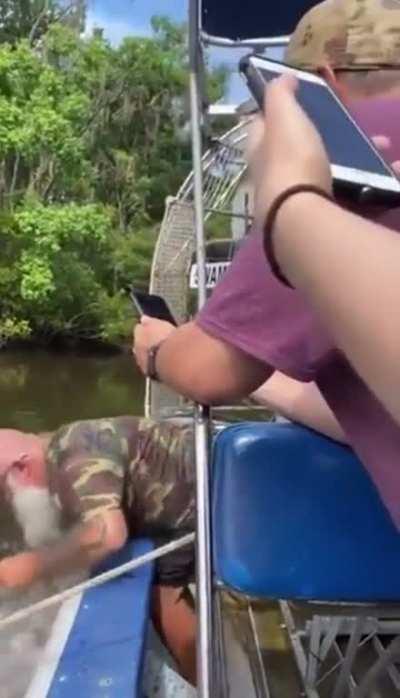 Man gets bitten by alligator, shakes it off with ease.