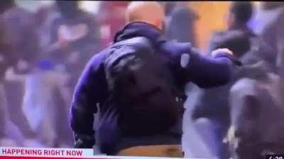 News team security detail disarms protestor with stolen rifle