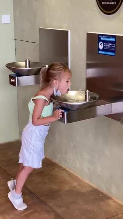 Trying to drink from a waterfountain