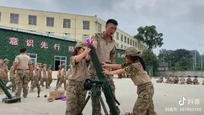 Chinese kids learn how to fire a mortar... What's going on? Source:  