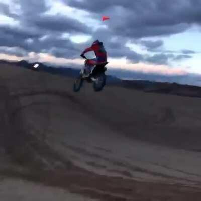 WCGW riding a dirt bike on the dunes