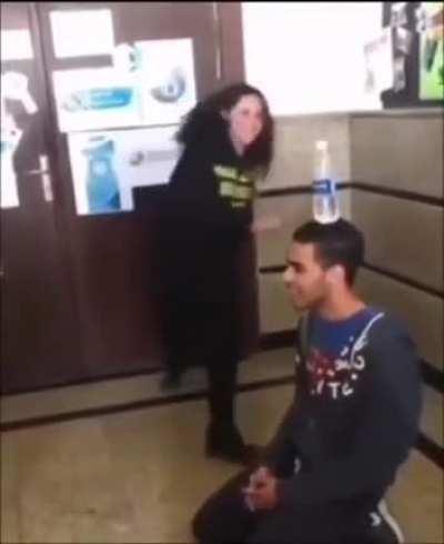 Trying to kick a water bottle off someone's head..