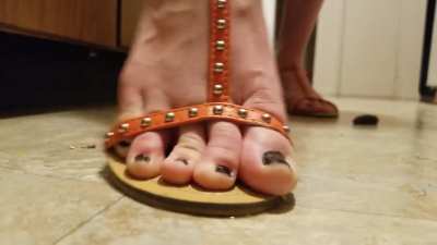 Flat sandals crushing snails and slug