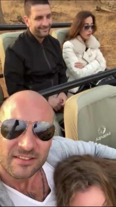 Both men smiling, one truly happy.