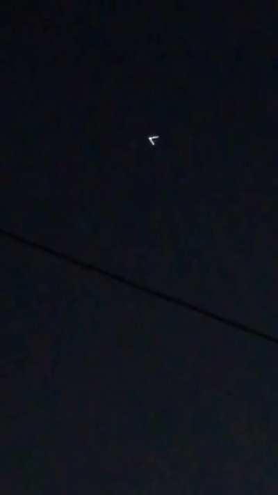 V- Shaped UFO Captured Glowing In The Night Sky