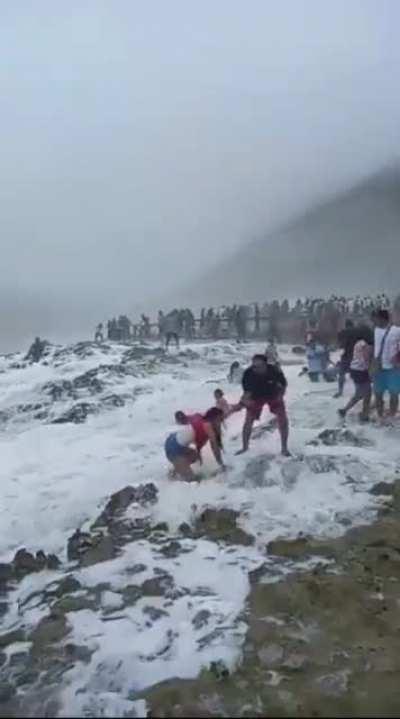 Playing near jagged rocks and rough crashing waves somehow goes wrong