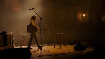 Ellie plays the guitar in the theater