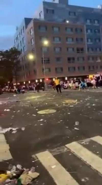 Chaotic scenes in Harlem as bottles and garbage are thrown at the police