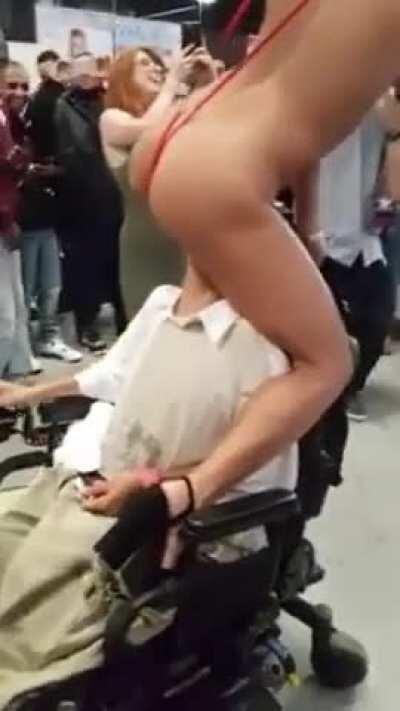 Adriana Chechik giving a disabled fan a taste