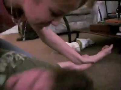 Big sister pins down brother and tries to drop spit on his face