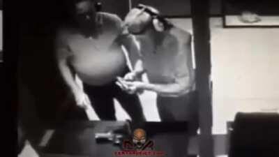 Testing a gun against his hand.