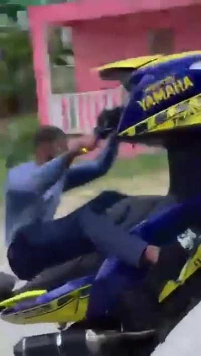 Motorcycle Rider doing a wheelie on side street