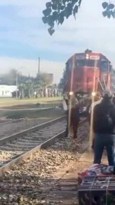 Woman wants to make sure she gets good shot of the train.