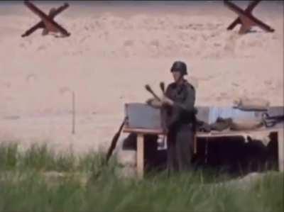 German soldier juggling grenades in Omaha Beach during World War II