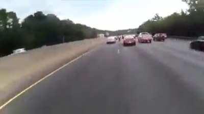 Bikes pass between cars in traffic