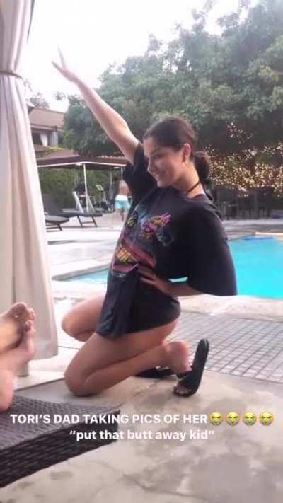 Lifting her shirt and showing her thong