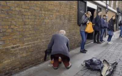 Taking a short cut behind a street performer