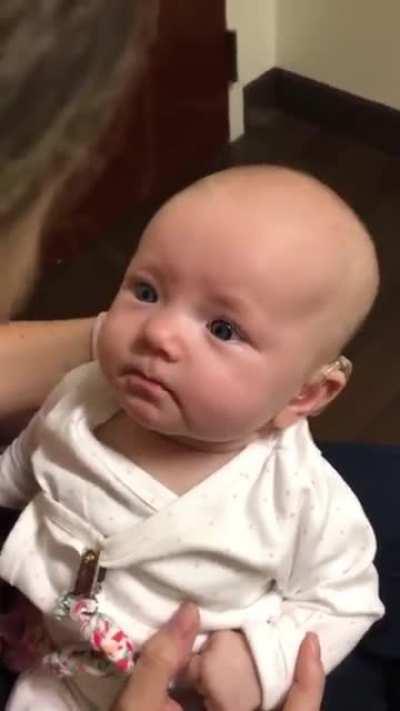 Baby hears mothers voice for the first time with the help of a hearing aid. the reaction is beautiful.
