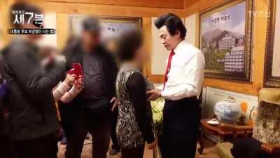 Korean cult leader giving blessings to his followers.