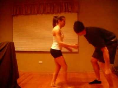 Small girl kicking a big guy in the nuts