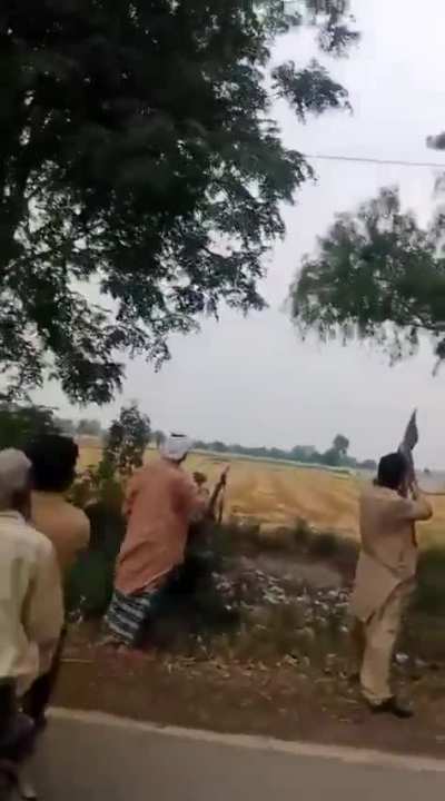A villager near Lahore borrows gun from a ranger to shoot down an Indian drone
