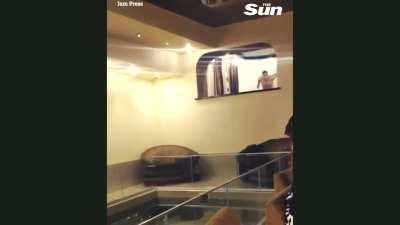 Idiot jumps into pool and breaks glass railing as he is diving in!