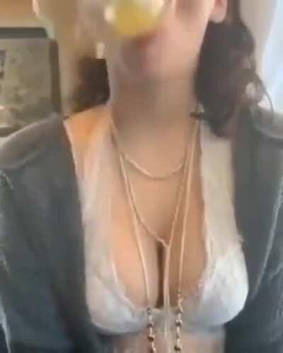 Woman tries to gulp a glass of OJ without using her hands