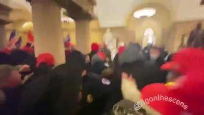 The crowd rushes a line of police attempting to block access to inner parts of the Capitol. Police are forced to retreat and stand down. Washington DC Riots.
